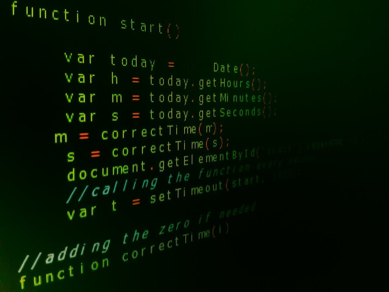 Close-up of JavaScript code on a computer screen with green text highlighting syntax.